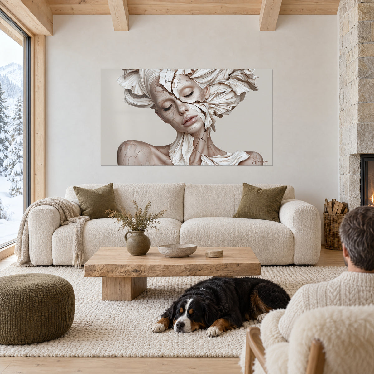 Wall art cracked statue face, ivory and blush beige petal headpiece, black dog lying down, above a sofa in a bright living room