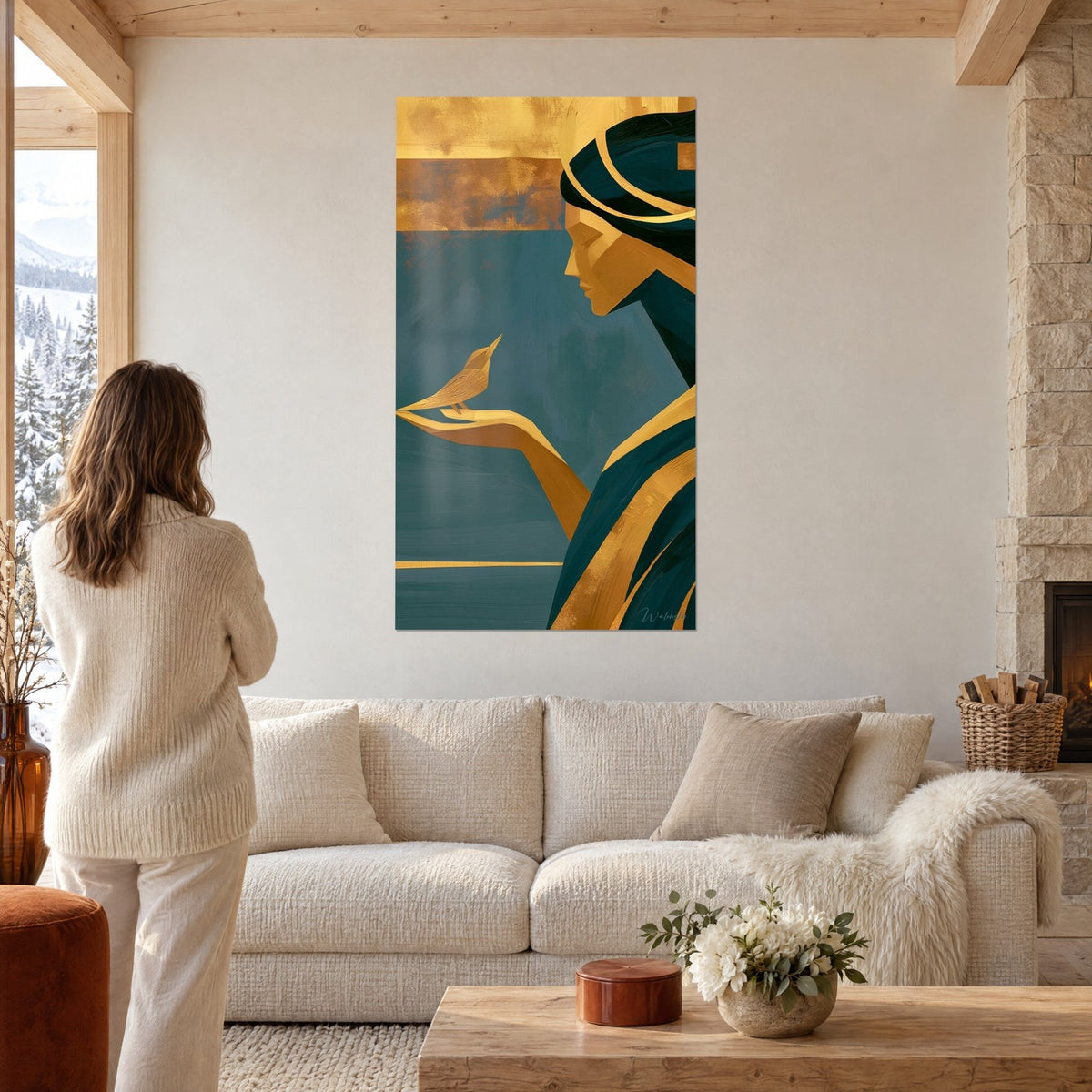 Wall art profile of a golden woman in deep teal and gold, a bird perched on her hand, above a sofa in a bright living room