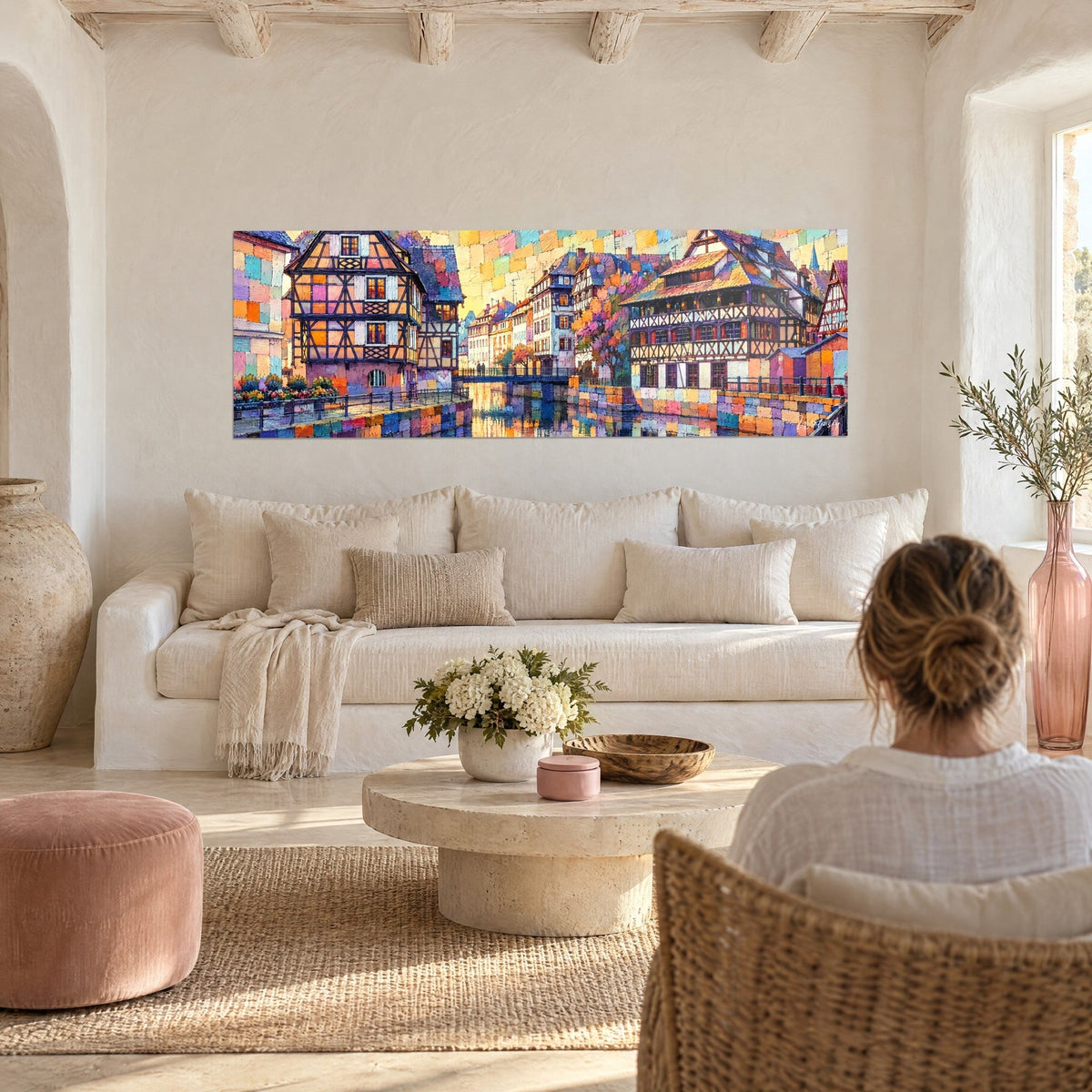 Quadro case a graticcio in mosaico arancione e blu, canale dorato, una donna di spalle, sopra un divano in un soggiorno luminoso