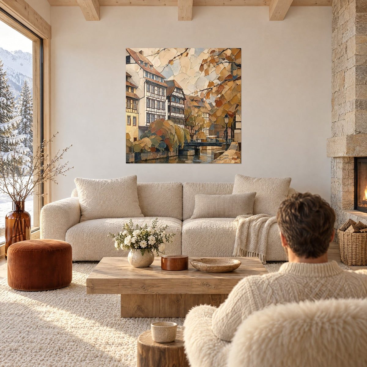 Cuadro casas con entramado de madera junto a un canal, fachadas crema y tejados ocres, sobre un sofá en un salón luminoso