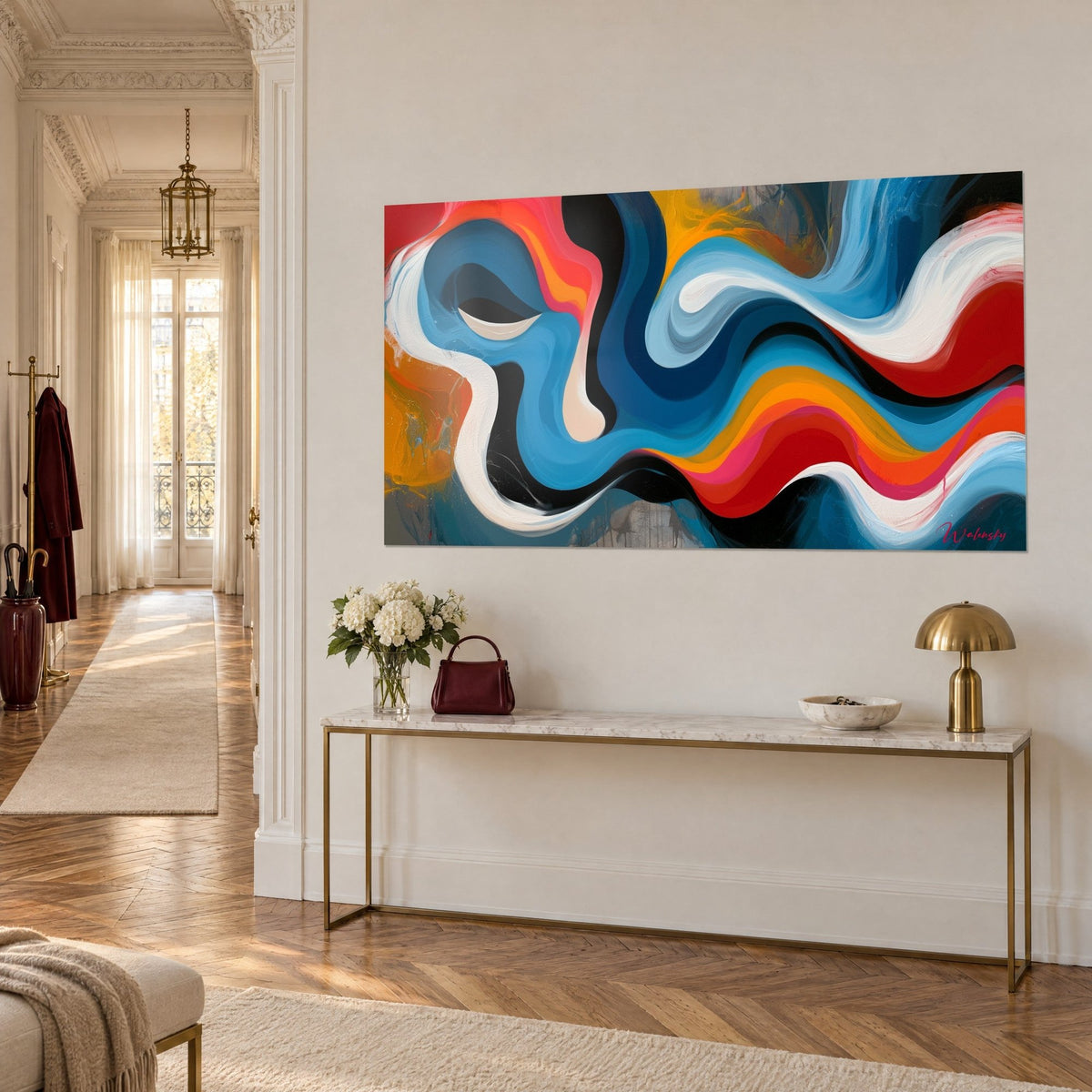 Wall art with a chromatic swirl of orange and petrol blue ribbons, grey drips on the left, on a gilded console in a Haussmann-style hallway