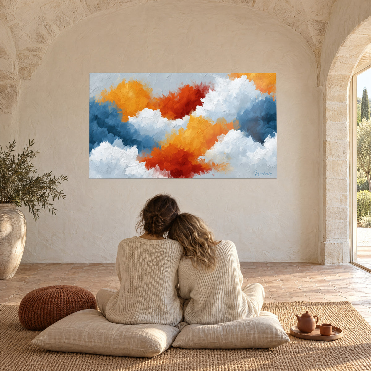 Tableau explosion de nuages orange, rouge et blanc cassé, contemplée par deux personnes enlacées de dos sur des coussins, sous une voûte de pierre
