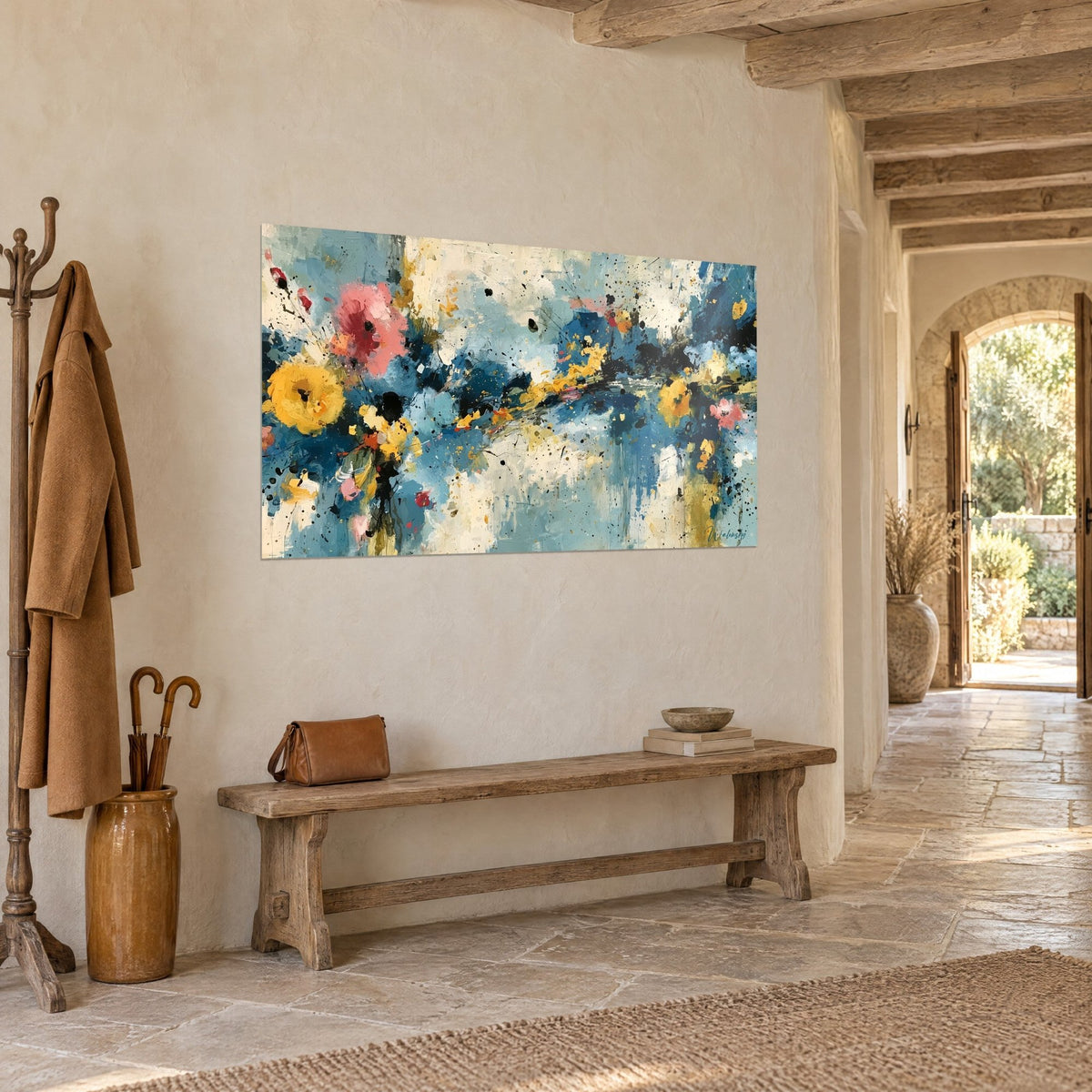 Wall art abstract floral painting, black splatters on sky blue and cream background, above a wooden bench
