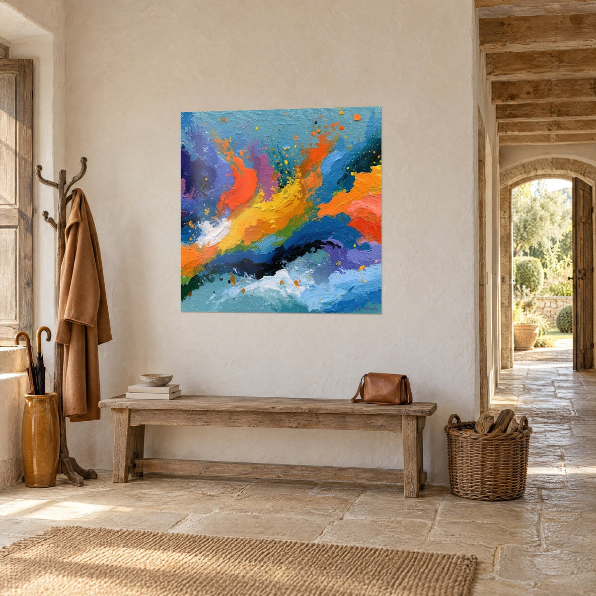 Wall art with a burst of vivid orange and violet splashes over blue waves, hung on a stone wall beside an arch