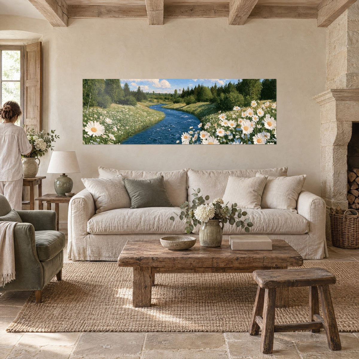 Wall art of a deep blue river winding between white daisies and green meadow, above a sofa in a bright living room