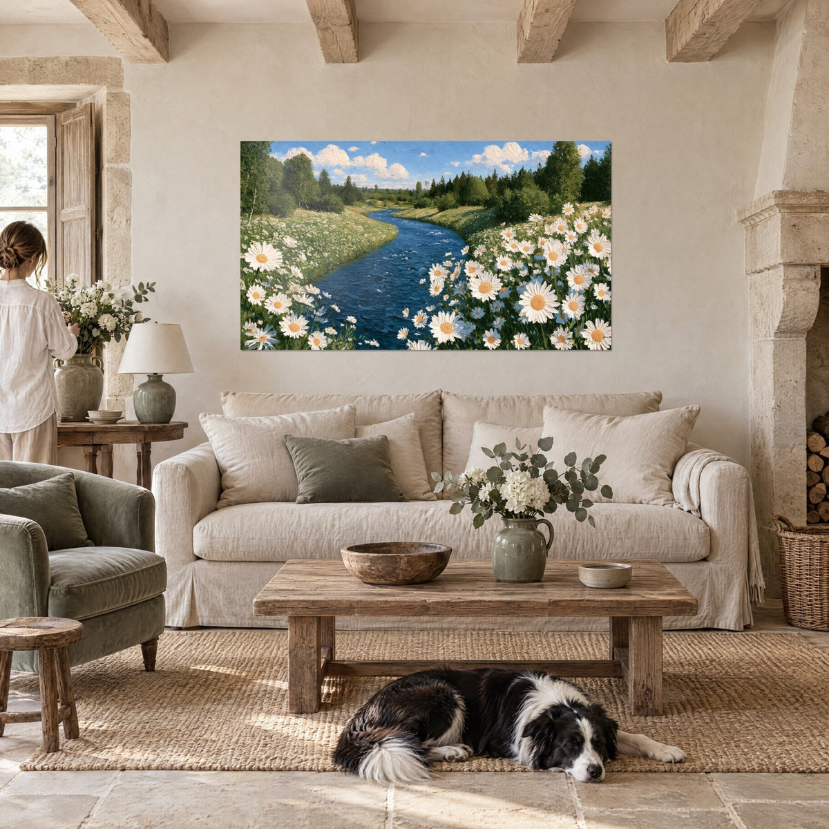 Wall art deep blue river winding between white daisies and green meadow, a collie lying down, above a sofa in a bright living room