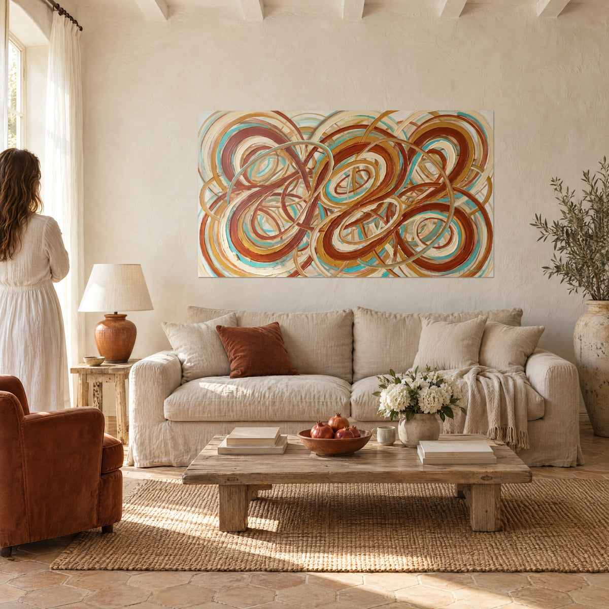 Quadro anelli intrecciati in terracotta e turchese, empasto avorio, una donna di spalle sopra un divano in un soggiorno luminoso