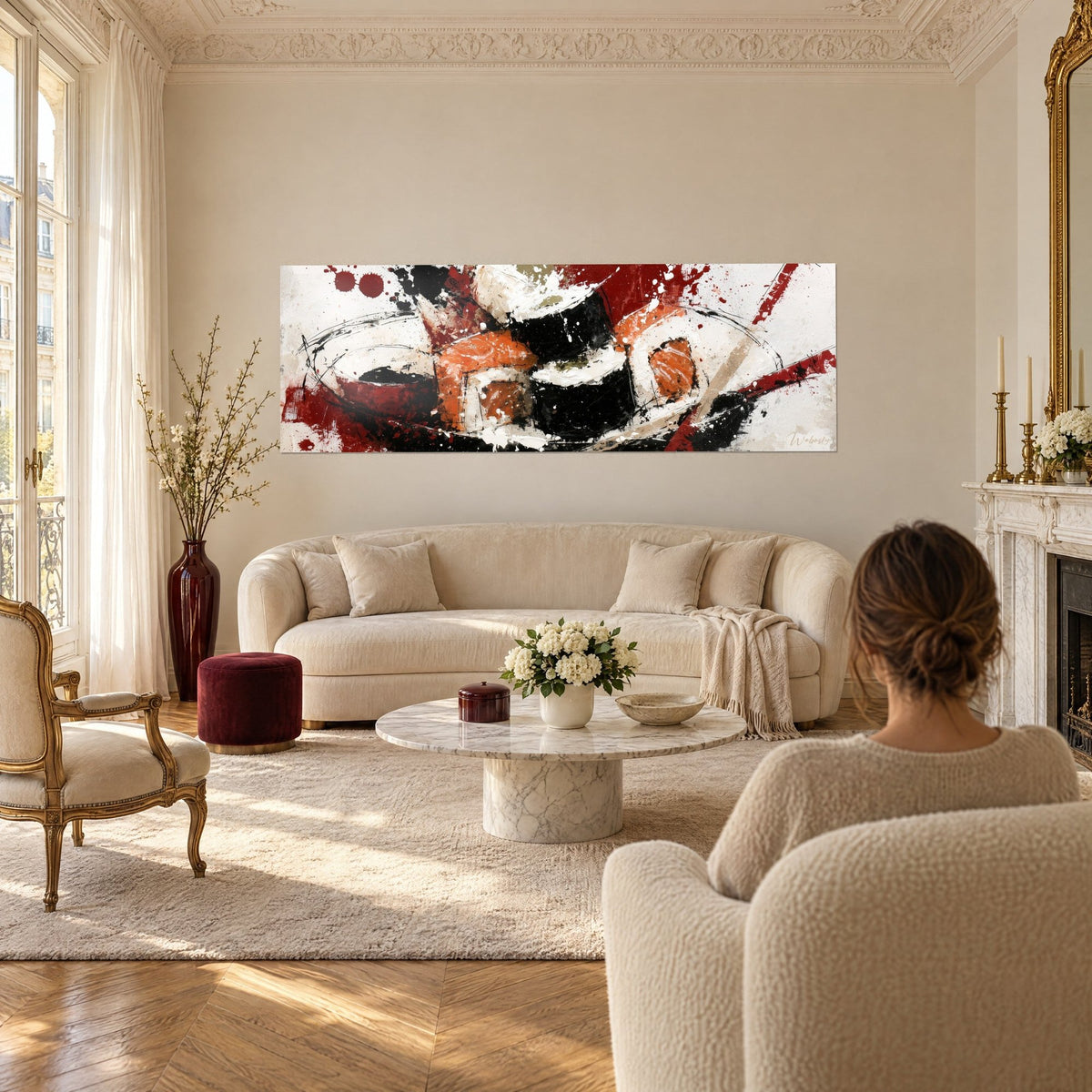 Tableau maki noir et saumon orange, éclats rouge sang sur fond ivoire, au-dessus d'un canapé dans un salon lumineux