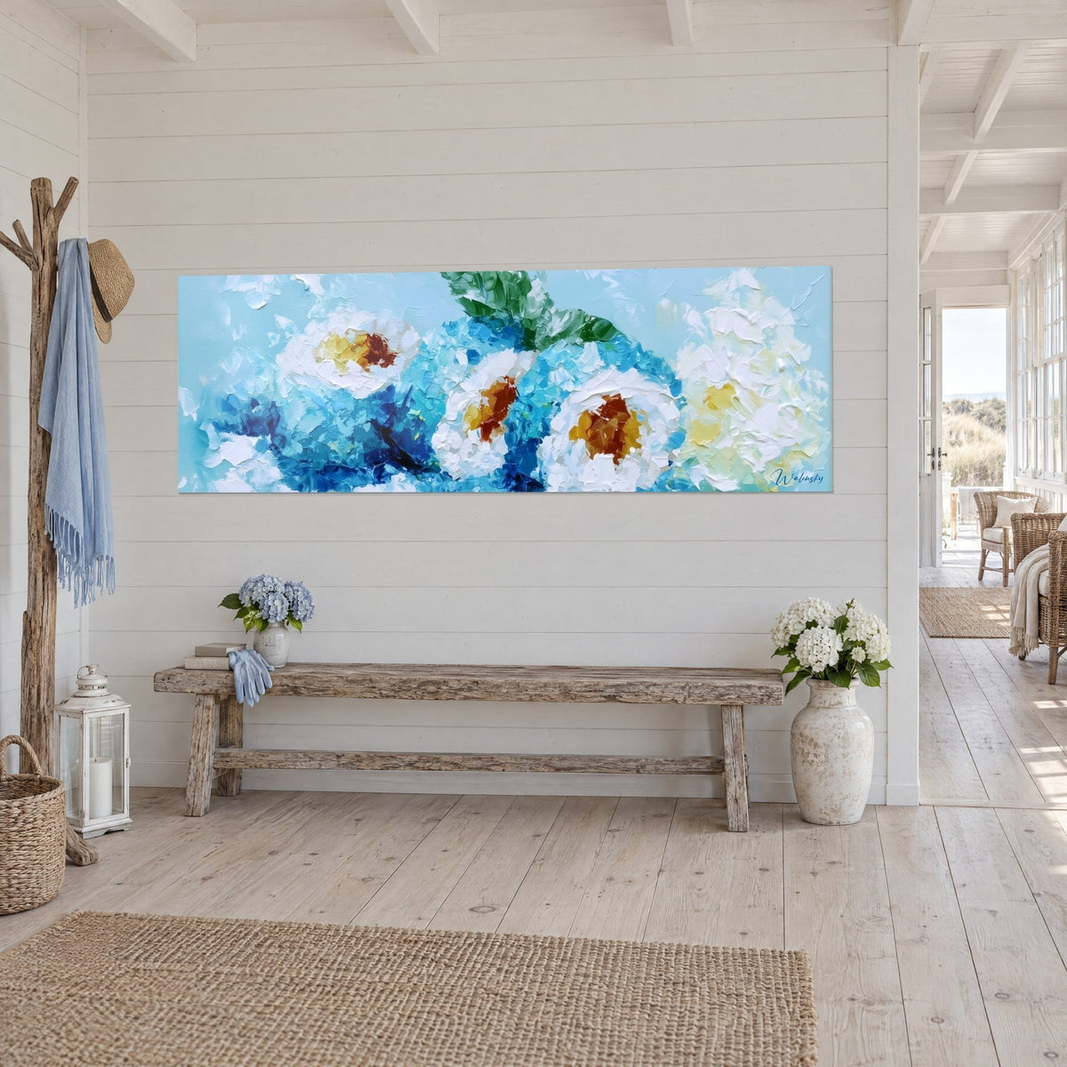 Wall art of floral rice rolls, ochre-orange hearts, cobalt blue and thick white, on a paneled wall, raw wood bench