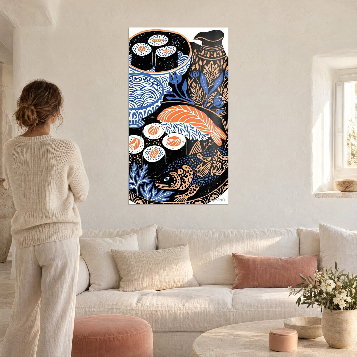 Wall art Japanese still life of black sushi and orange salmon, blue bowls, woman seen from behind, above a sofa in a bright living room