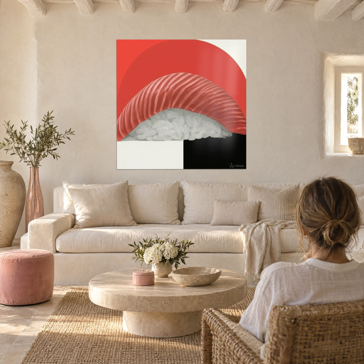 Wall art of bright red tuna nigiri on white rice, scarlet half-sun and black square, hung above a sofa in a bright living room