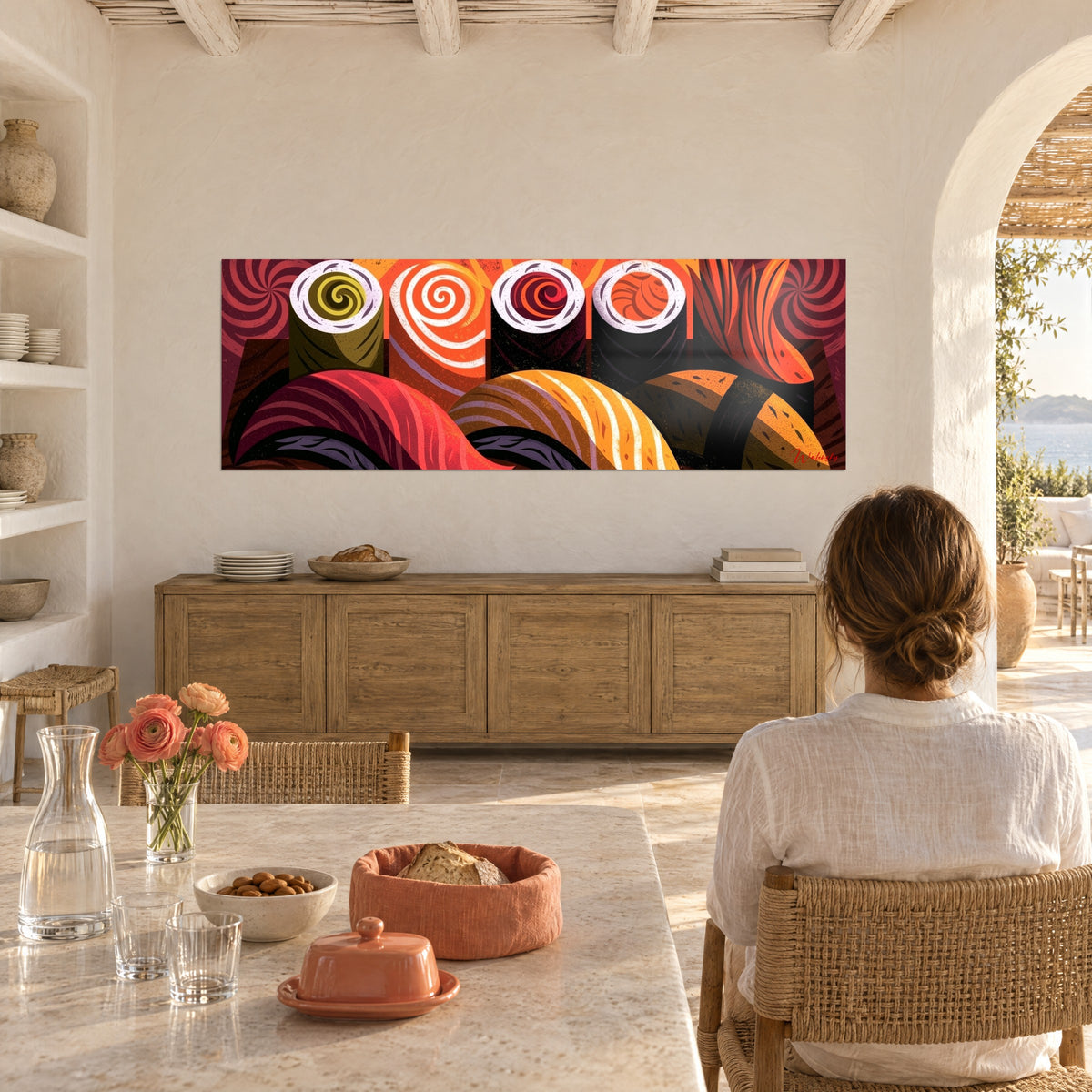 Wall art four white rice rolls with red and orange spirals on a burgundy background, woman seen from behind at a table in a bright everyday moment
