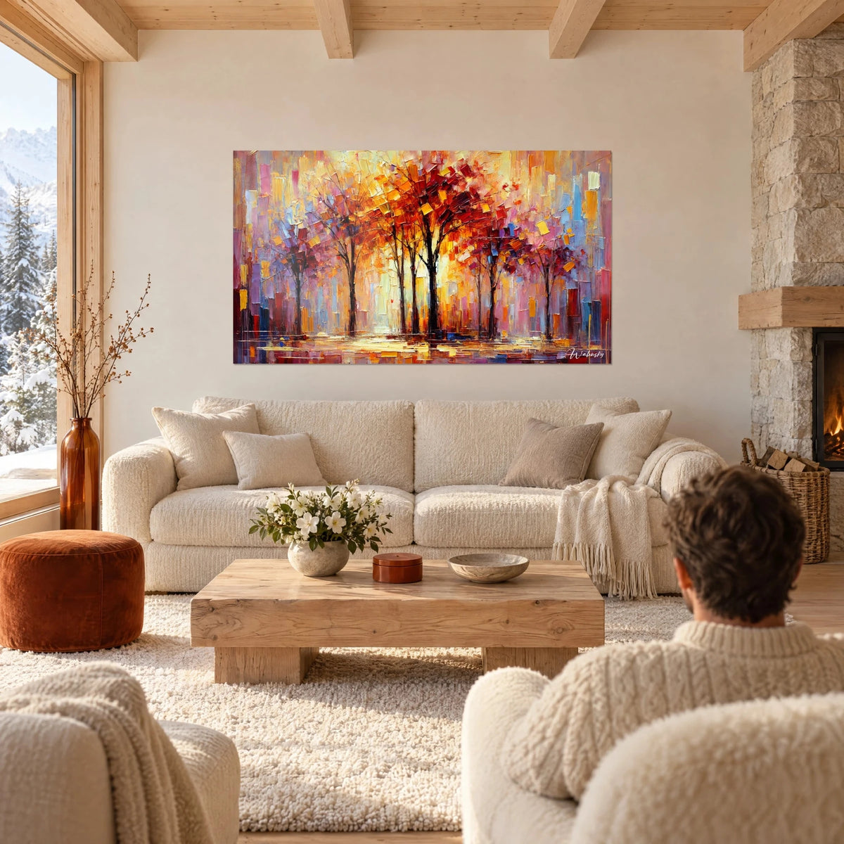 Wall art alley of blazing trees with red and ochre leaves, couple seen from behind, above a sofa in a bright living room