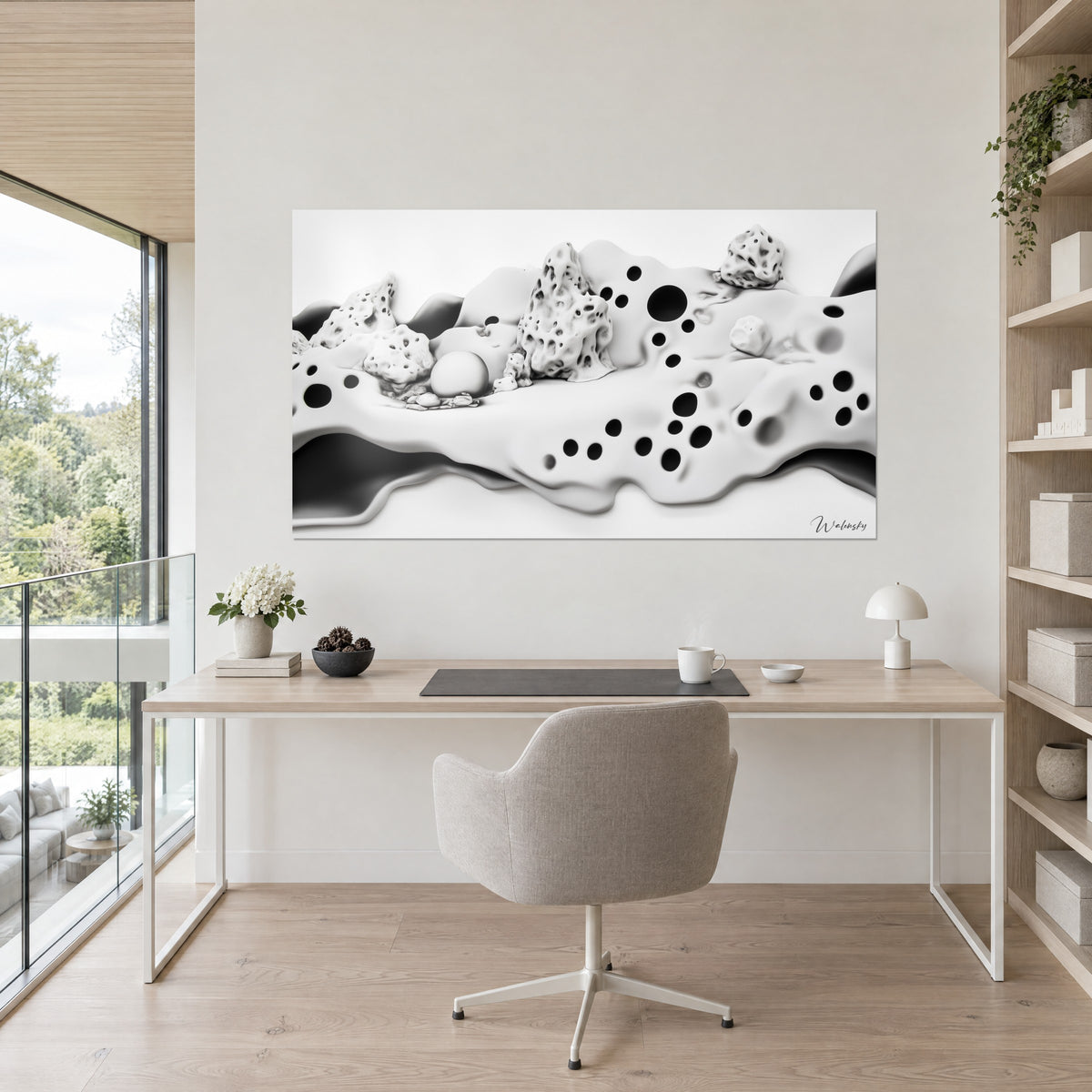Cuadro mundo lunar blanco salpicado de agujeros de tinta negra, piedras ahuecadas y esfera lisa, en la pared de un despacho de madera clara