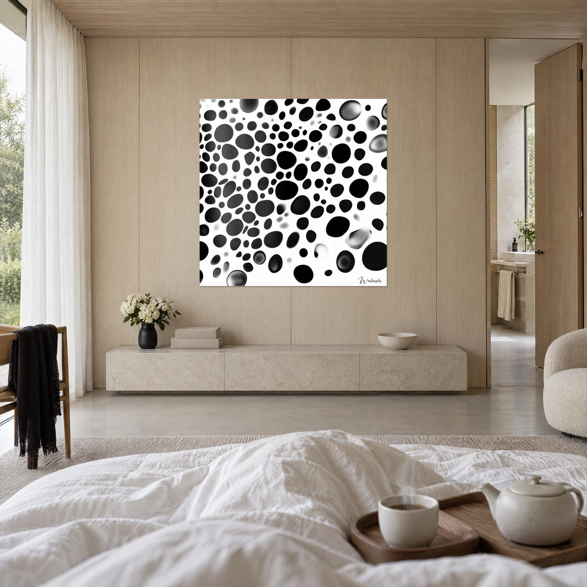 Wall art with black and white ink bubbles with dotted edges, facing a white bed, above the bed in a bright bedroom