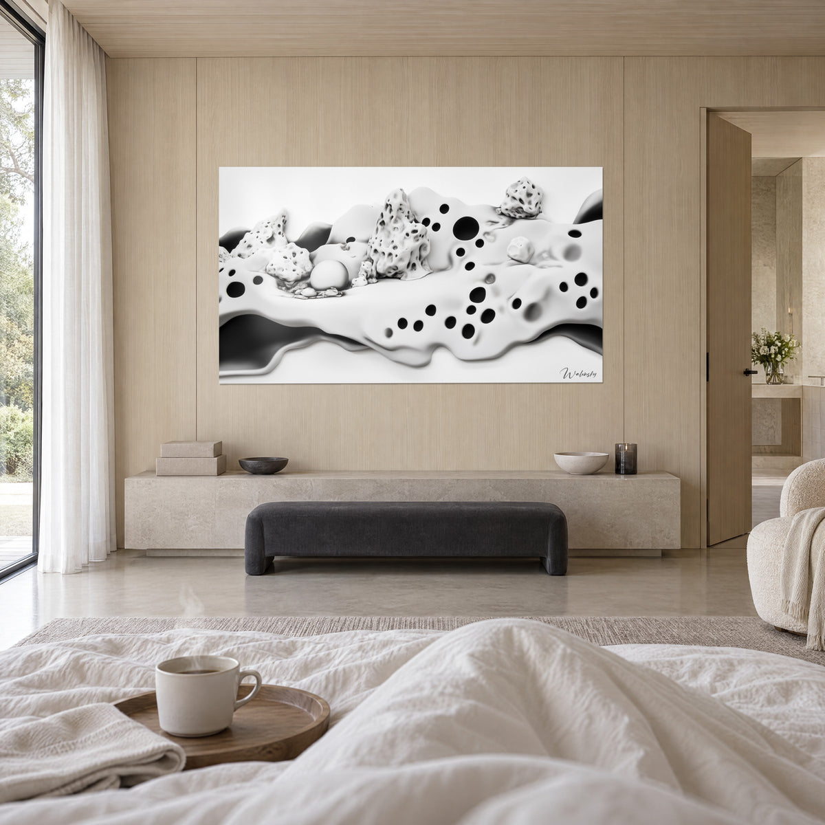 Cuadro colada cremosa blanca perforada con discos negros, rocas esponjosas arriba, persona de espaldas sobre una cama en un dormitorio luminoso