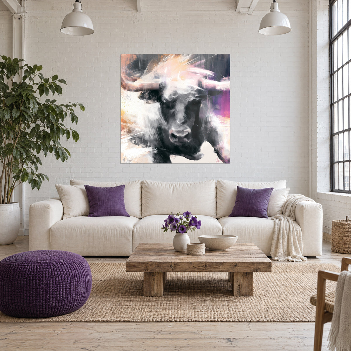 Wall art Black bull with mauve horns, white and pale pink brushstrokes, above a sofa in a bright living room