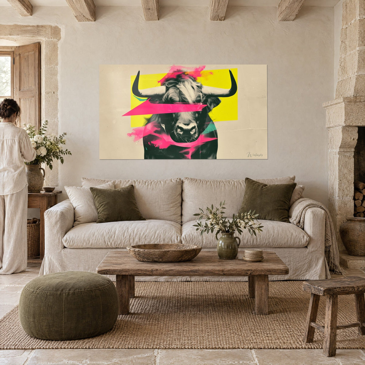 Quadro toro in bianco e nero, corna scure, campiture giallo limone e rosa fluo, sopra un divano in un soggiorno luminoso