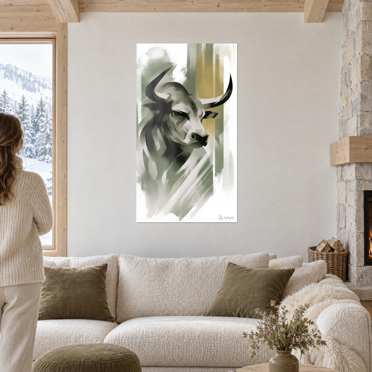 Wall art of a stylised bull with black horns, sage green and ochre flat tones, two people seen from behind above a sofa in a bright living room