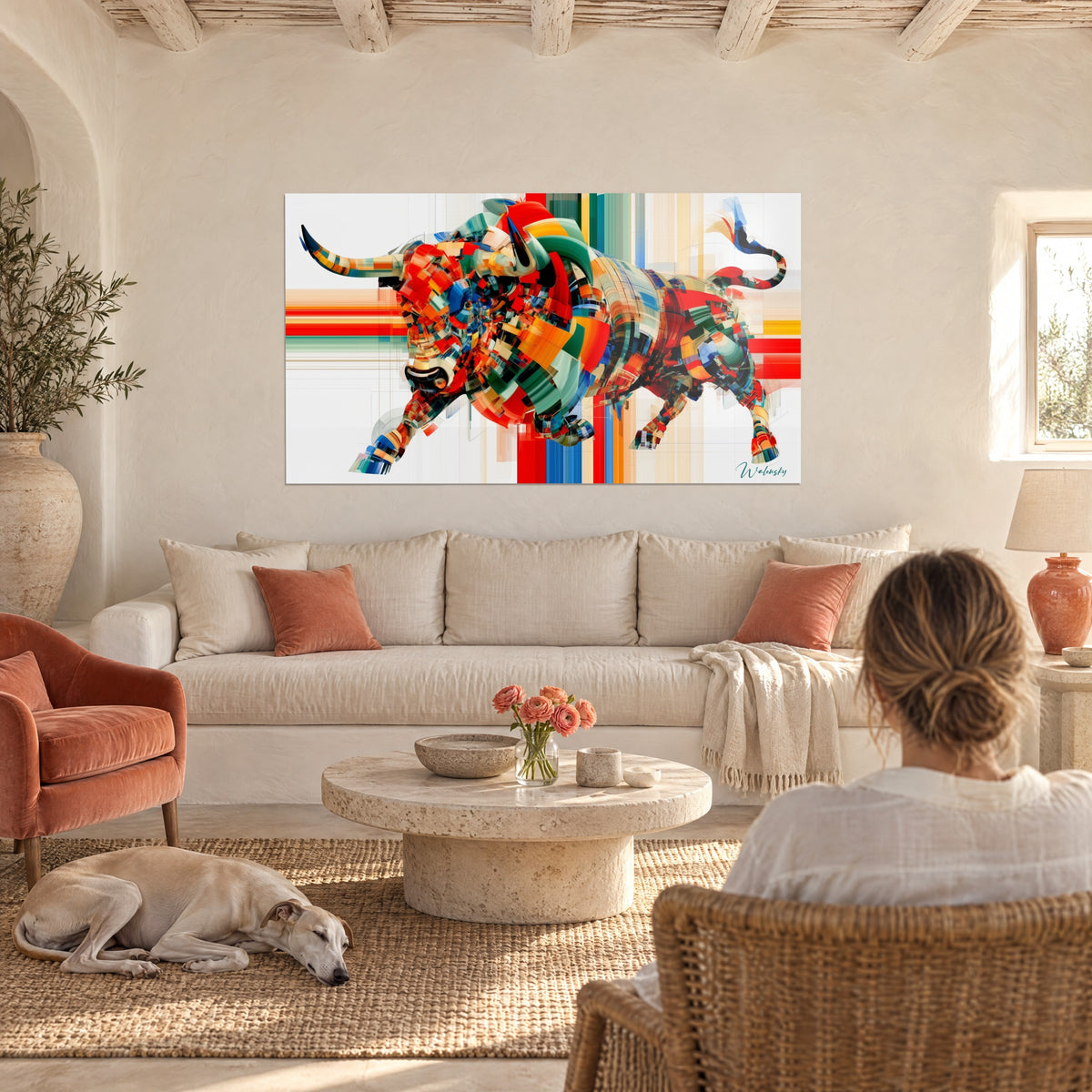 Gemälde kubistischer Stier in Rot und Grün, Körper aus orangefarbenen und blauen Facetten, schwarze Hörner, über einem Sofa in einem hellen Wohnzimmer