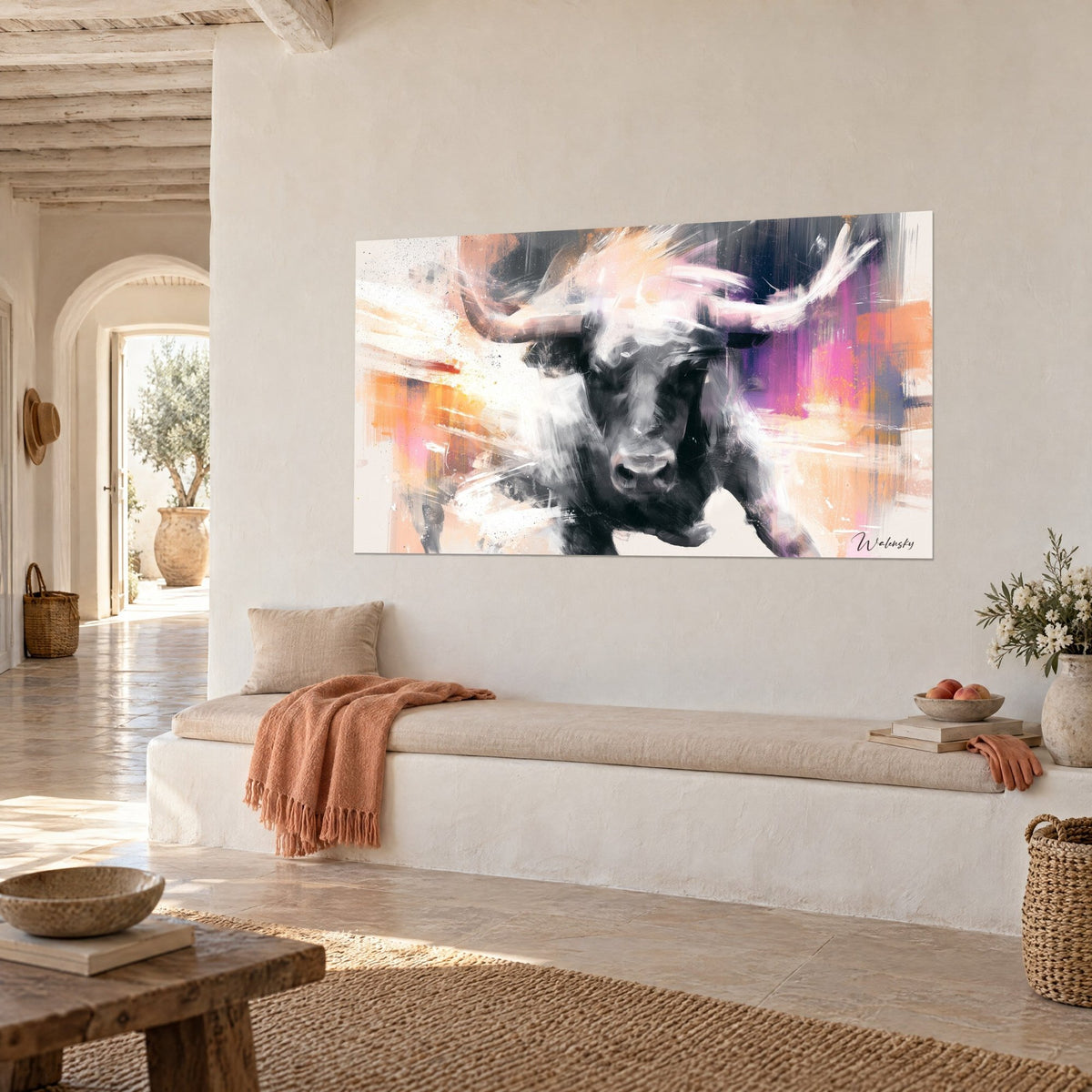 Wall art massive bovine with a white-brushed muzzle, pink and orange streaks on a cream wall, Mediterranean house in three-quarter view