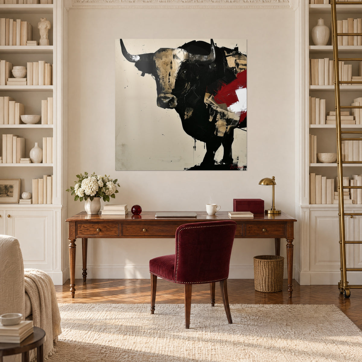 Cuadro silueta de toro oscuro, mancha roja y cruz blanca, entre dos estanterías marfil encima de un escritorio de madera