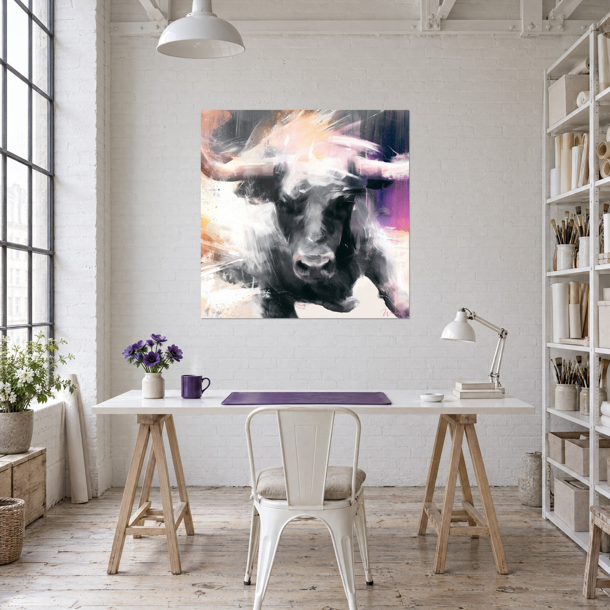 Wall art Bull head with rosy horns on a white and violet background, hung above a wooden desk and a shelf