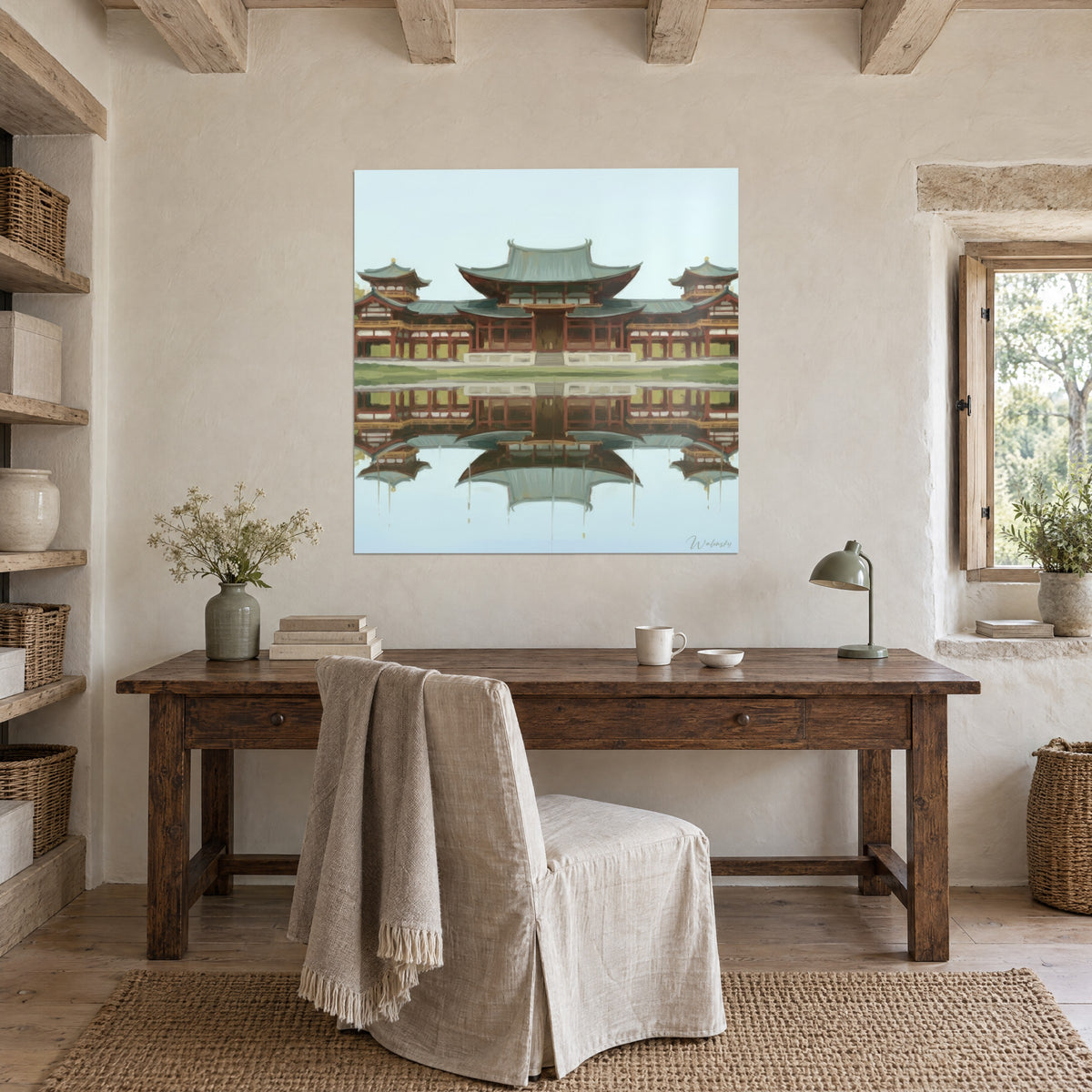 Cuadro de arquitectura japonesa con alas simétricas, pilares rojo ladrillo y césped verde, colgado encima de un escritorio de madera