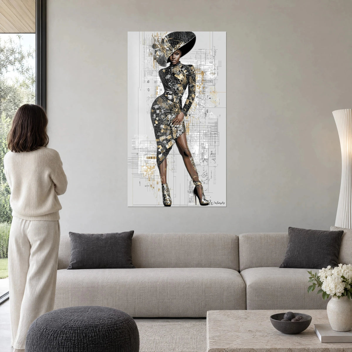 Schilderij model in zwart-gouden mozaïekjurk onder een hoed met brede rand, grijze architectentekeningen, boven een bank in een lichte woonkamer