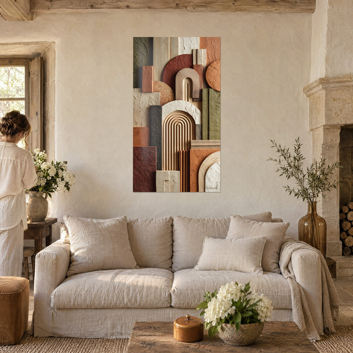 Schilderij met gebeeldhouwde boogreliëfs in beige en terracotta, gestreepte crème gewelf, een vrouw van achteren boven een bank in een lichte woonkamer