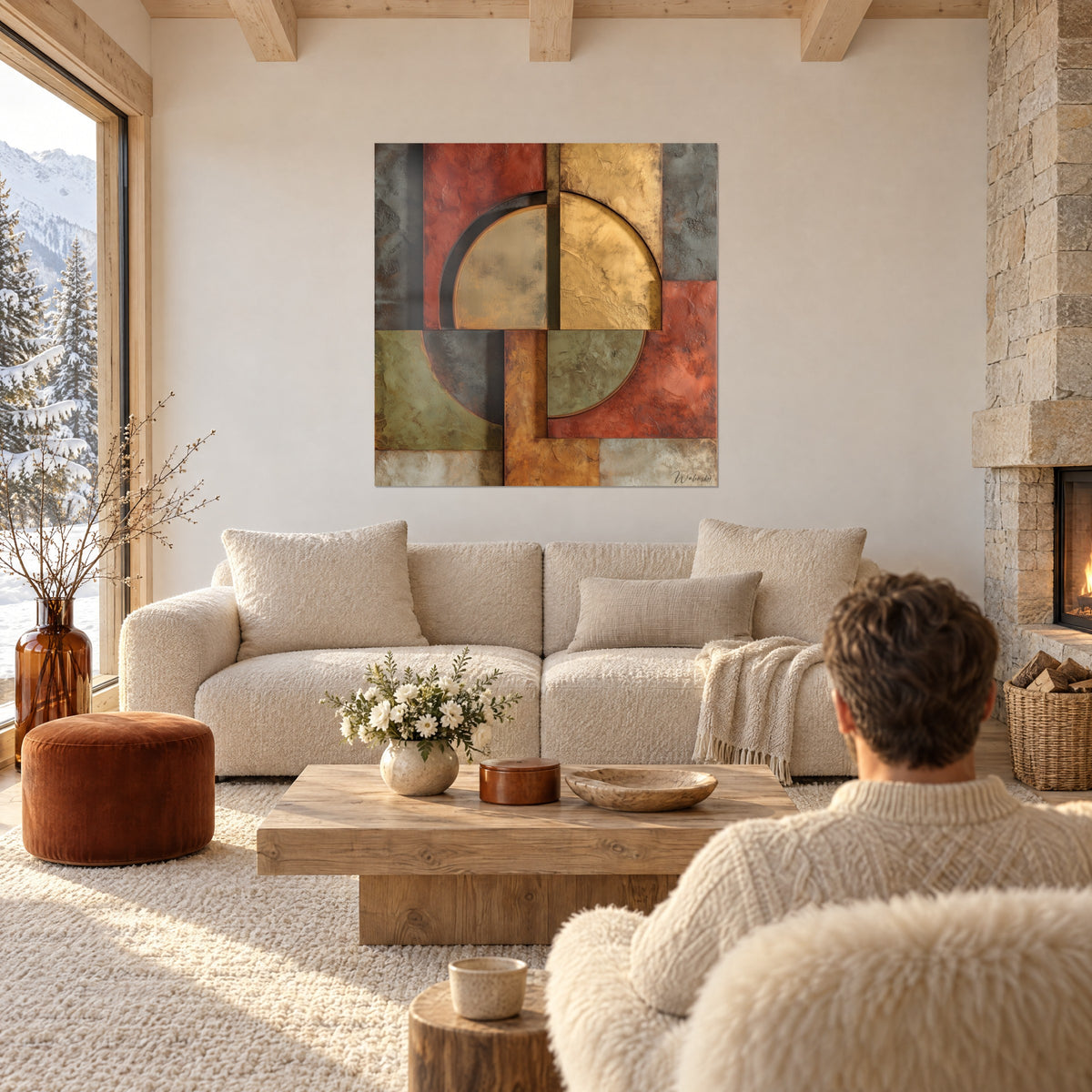 Wall art with golden half-circles on rust and sage blocks, seen from behind by a man, above a sofa in a bright living room