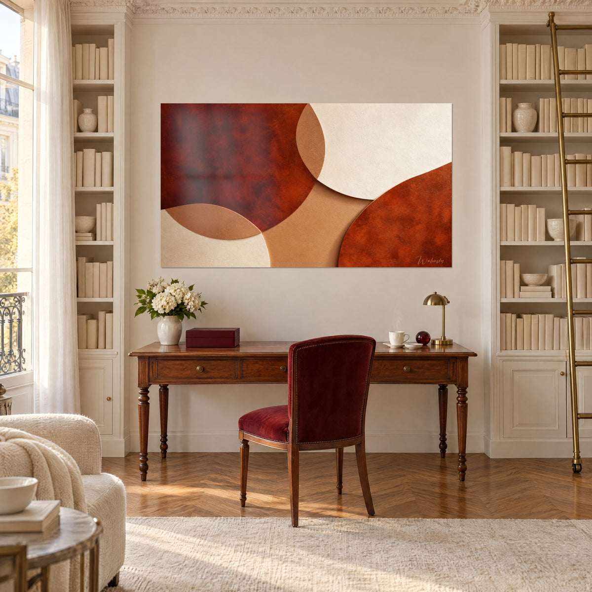 Tableau cercles superposés rouge brique et sable clair, accroché entre deux bibliothèques blanches au-dessus d'un bureau