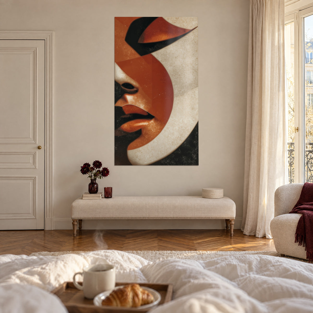 Quadro maschera femminile con labbra arancio, grandi campiture ruggine e crema su nero, sopra un letto in una camera chiara