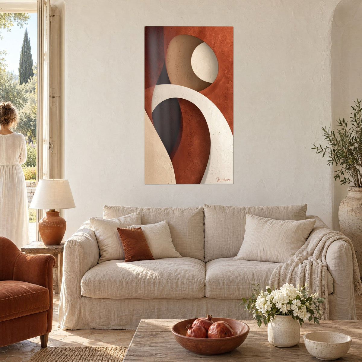 Wall art with an enigmatic silhouette in cream arches on a brick background, a woman seen from behind, above a sofa in a bright living room