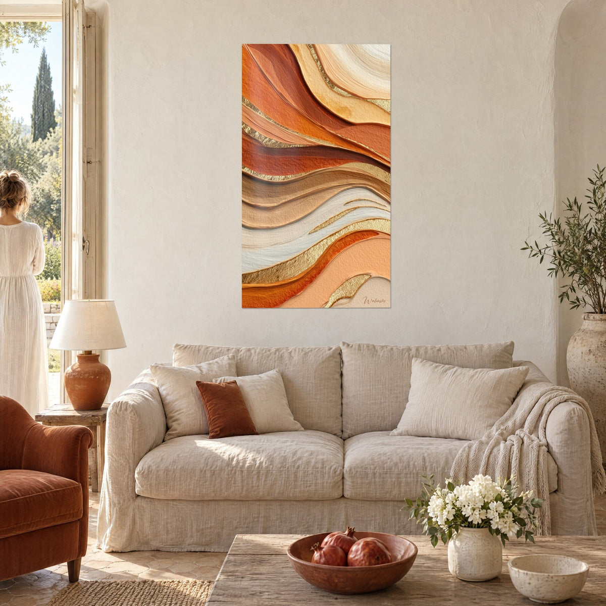 Wall art with sinuous ochre and copper waves, hammered gold lines, hung facing two people seen from behind above a sofa in a bright living room