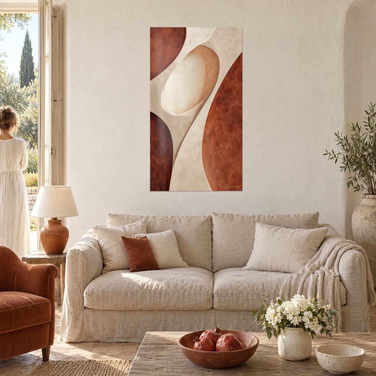 Wall art organic silhouette in sand and brick, cream oval edged with curves, seen from behind by a couple above a sofa in a bright living room