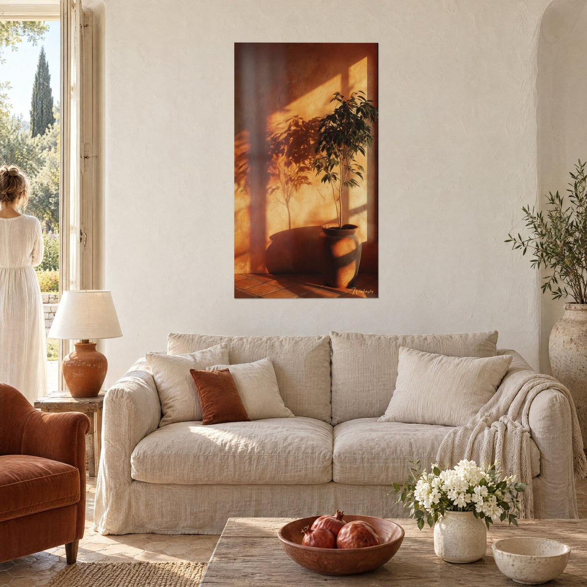Wall art ficus in ochre pot, leafy shadow on orange wall, two people seen from behind, above a sofa in a bright living room
