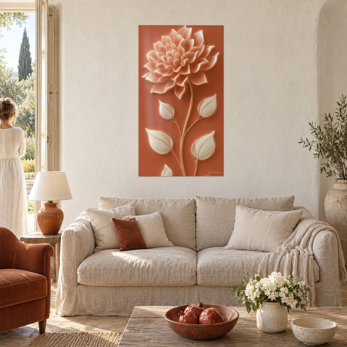 Wall art with a relief dahlia with peach petals on a terracotta background, golden stem and ivory leaves, above a sofa in a bright living room