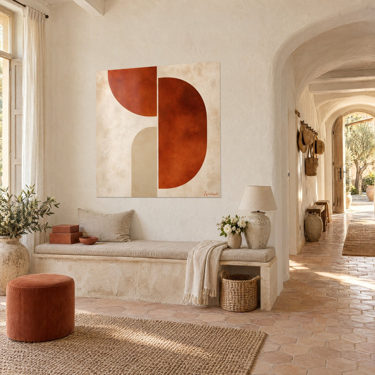 Wall art with terracotta geometric shapes on a sand checkered background, hanging in the vaulted corridor of pale stone in the farmhouse
