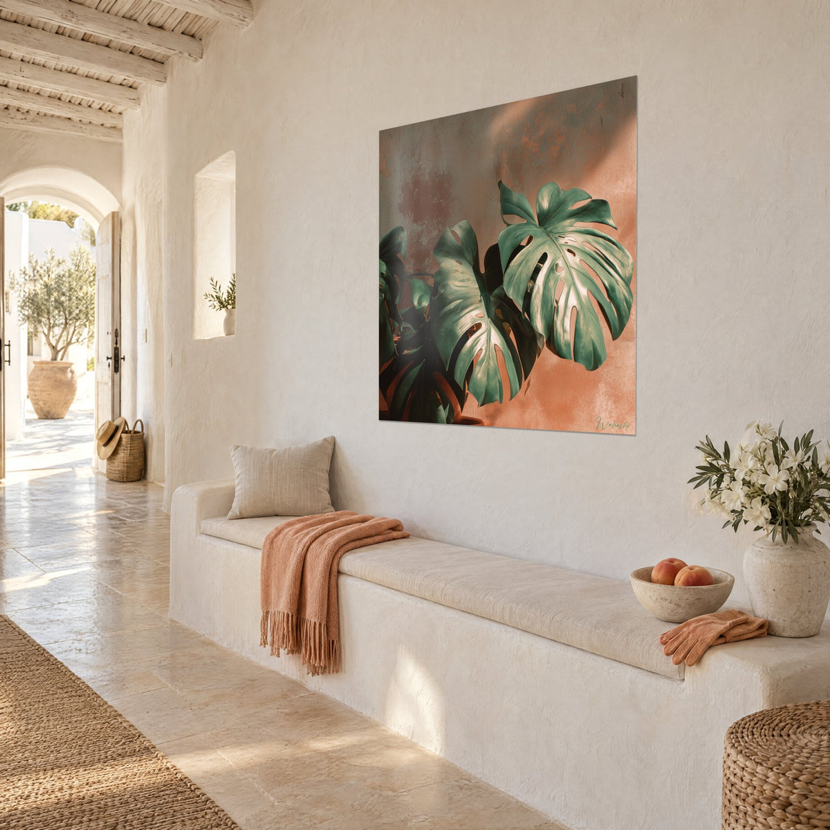 Wall art of a tropical plant with large perforated jade green leaves, speckled orange plaster, light stone bench