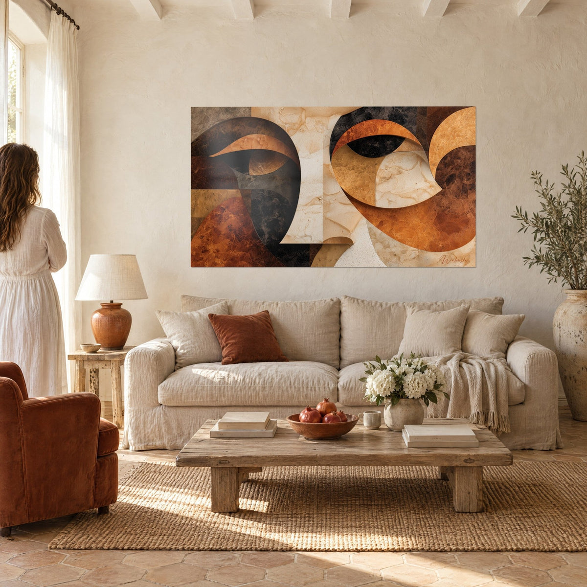 Wall art abstract face in ochre and charcoal arches, cream beige marbled tones, above a sofa in a bright living room