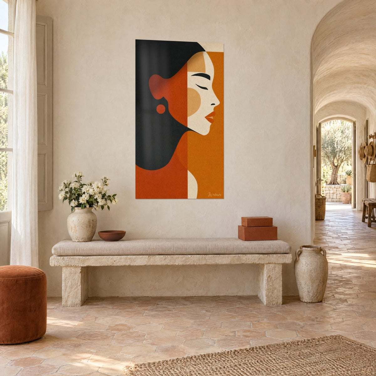 Quadro volto femminile stilizzato, labbra rosso mattone e guancia color sabbia, su un muro imbiancato di fronte a una panca in pietra in un mas