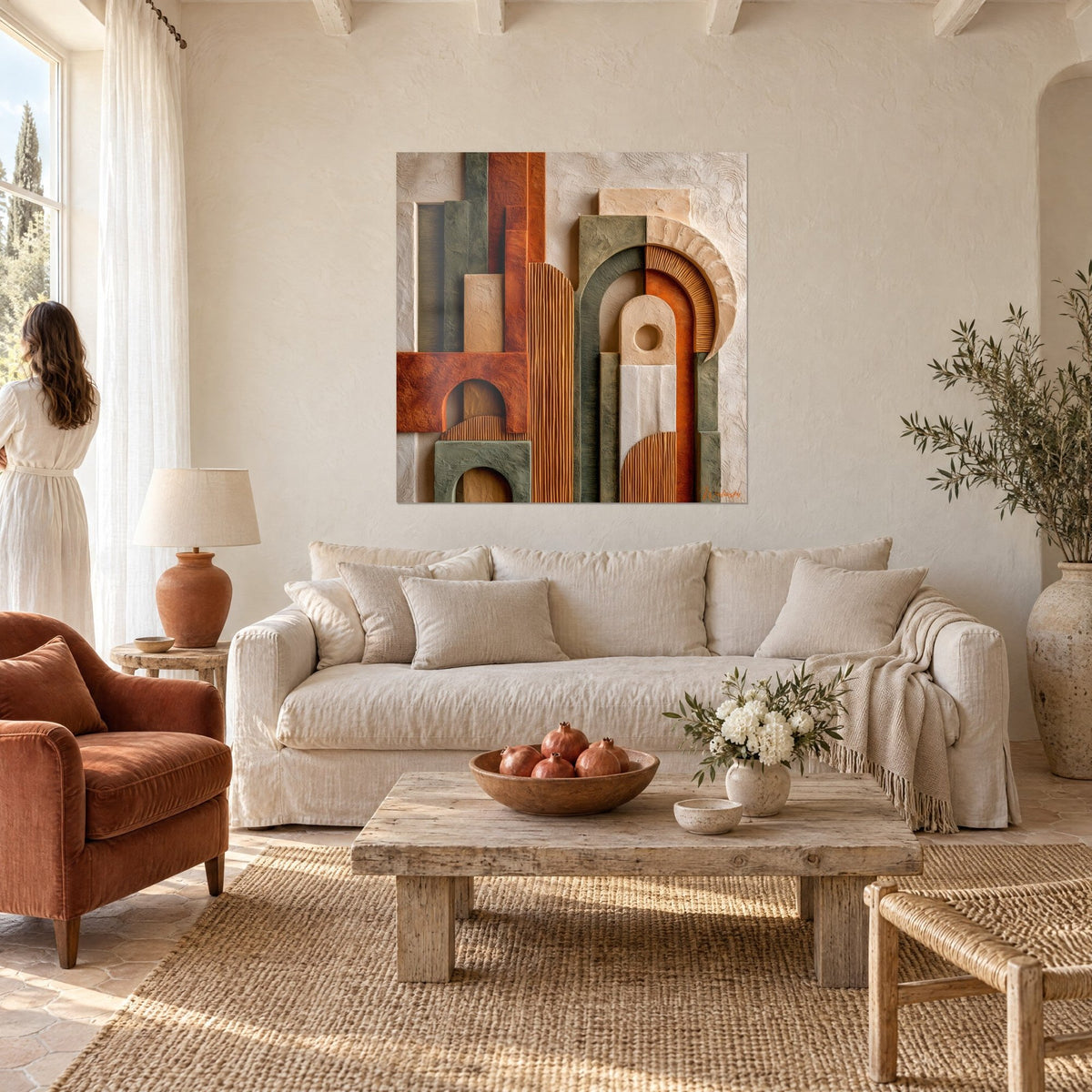 Wall art with sculpted arches in terracotta and sage green relief, striped ochre bands, above a sofa in a bright living room