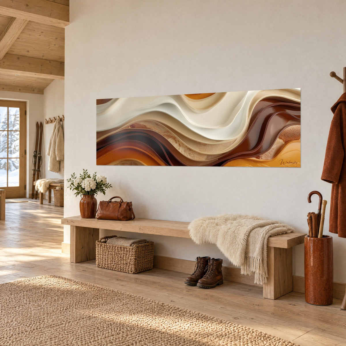 Panoramic wall art of wavy cream, chocolate and golden ochre ribbons, hung above a light wood bench in a chalet entrance hall