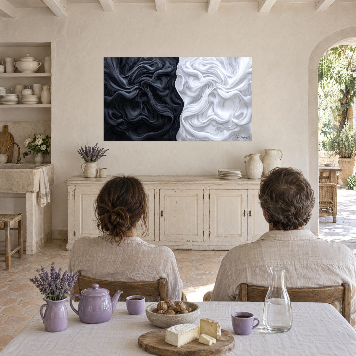 Abstract wall art of fluid reliefs, one half jet black and the other pure white, behind a couple seated at a table near an arch