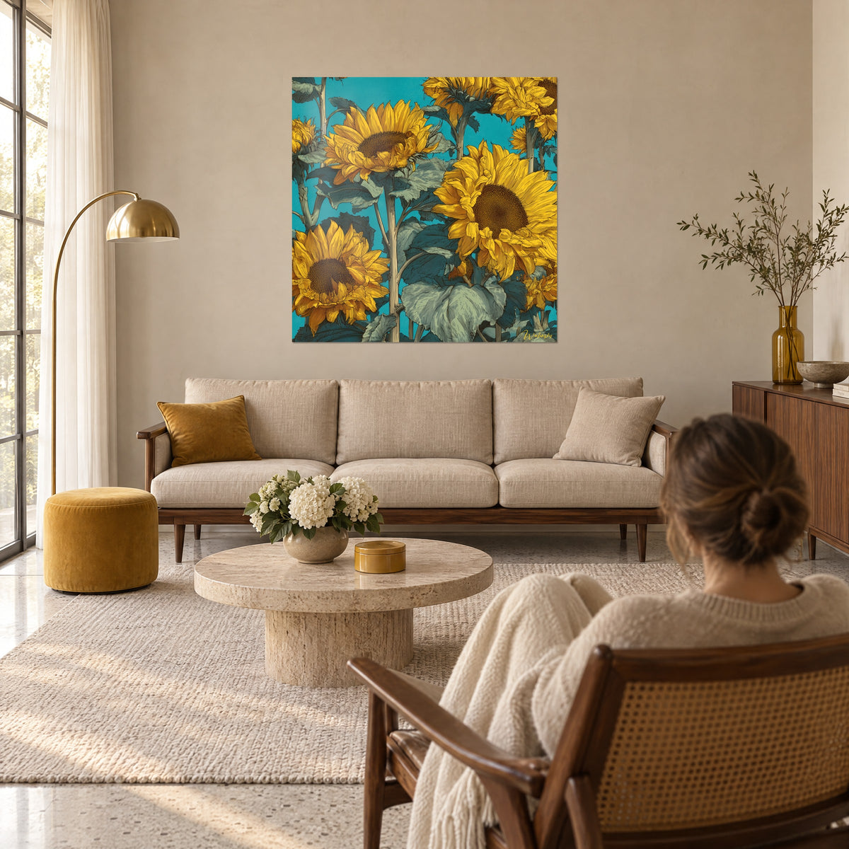 Wall art golden sunflowers with brown hearts on turquoise background, woman seen from behind, above a sofa in a bright living room