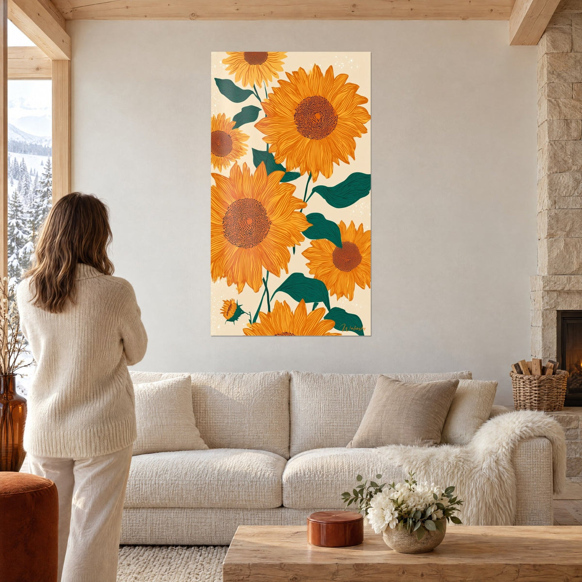 Wall art orange and teal sunflowers with striped petals, in front of a woman seen from behind, above a sofa in a bright living room