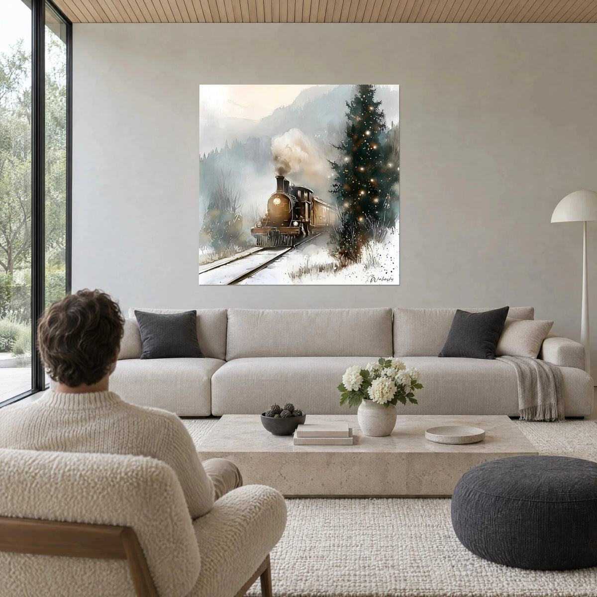Wall art bronze steam locomotive releasing a beige plume of smoke toward a sparkling fir tree, above a sofa in a bright living room