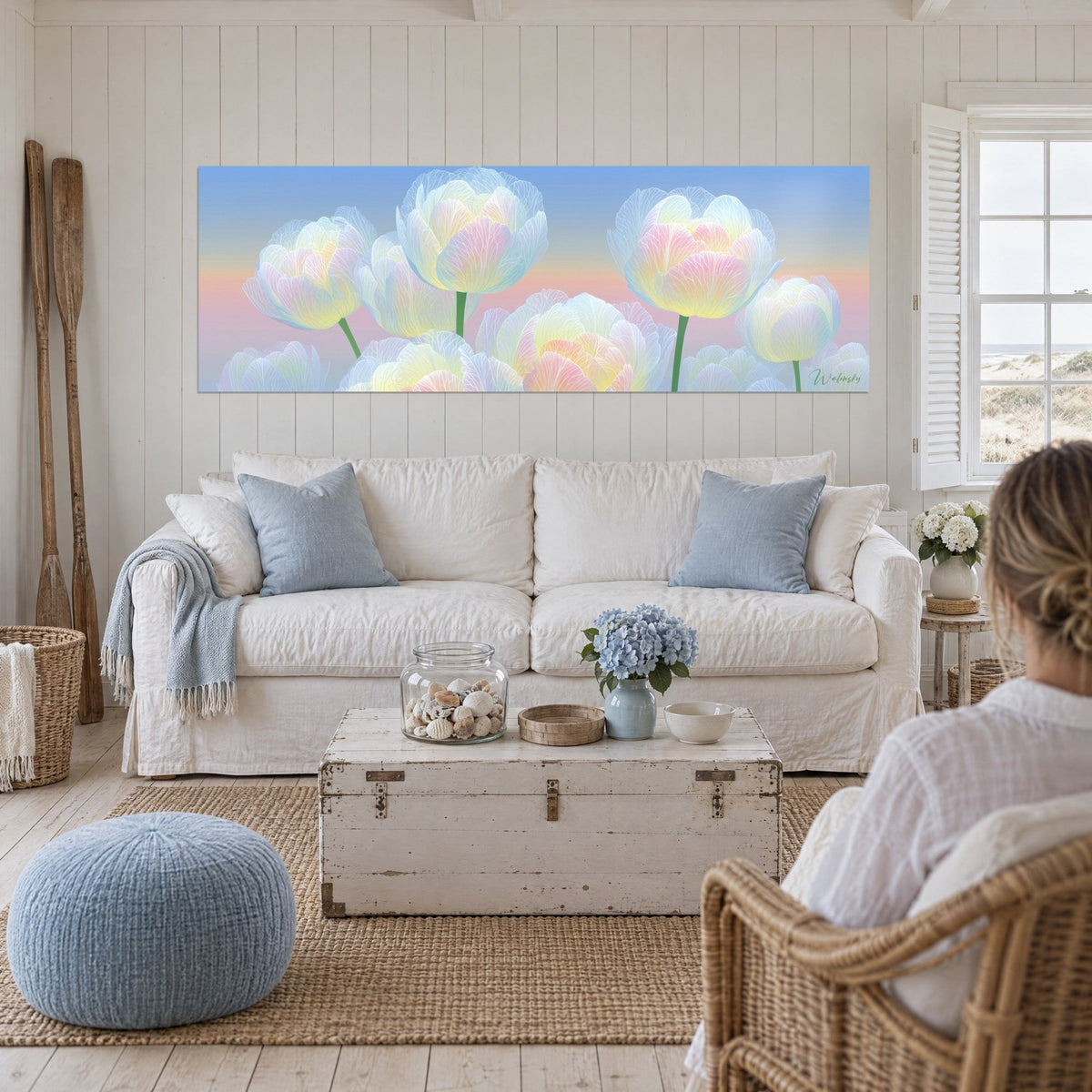 Wall art with translucent tulips with veined petals, sky blue and pale pink, above a sofa in a bright living room