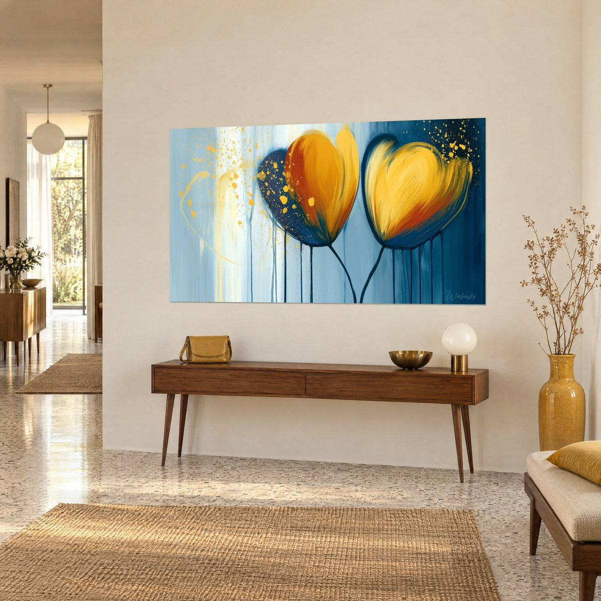 Wall art two heart-shaped flowers in amber and copper, golden splashes on a sky-blue background, above a wooden console, three-quarter view